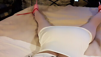 Laura, Adorned In A Seductive White Dress, Pink Tights, And Elevated Heels, Bound And Silenced On A Bed.